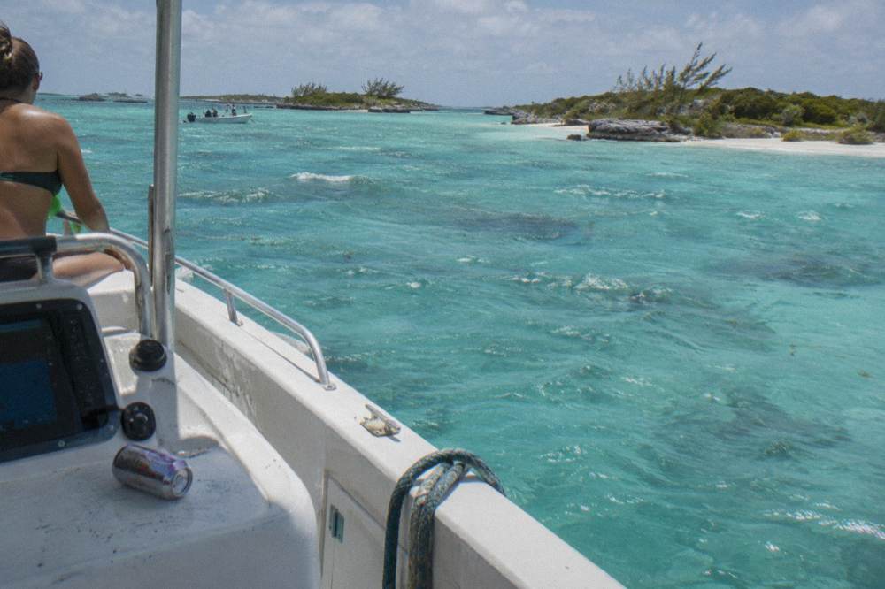 Turquoise shallows and small cays seen from a boat deck at midday