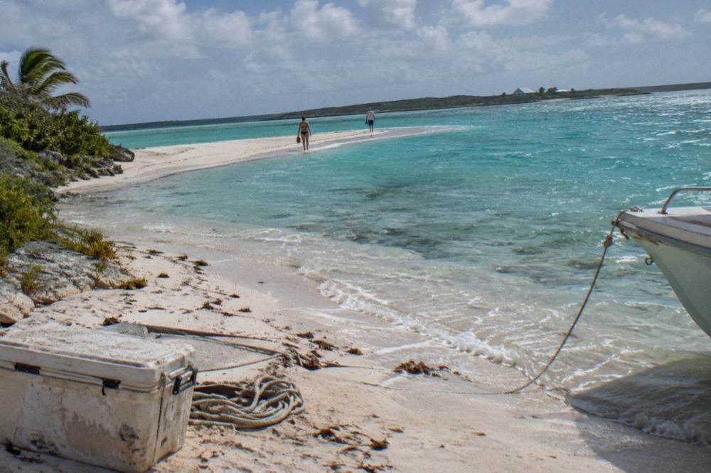 A white sandbar curving through bright turquoise open water