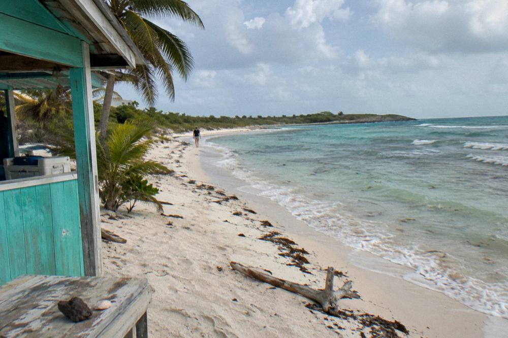 A quiet crescent beach with clear shallow water and no people