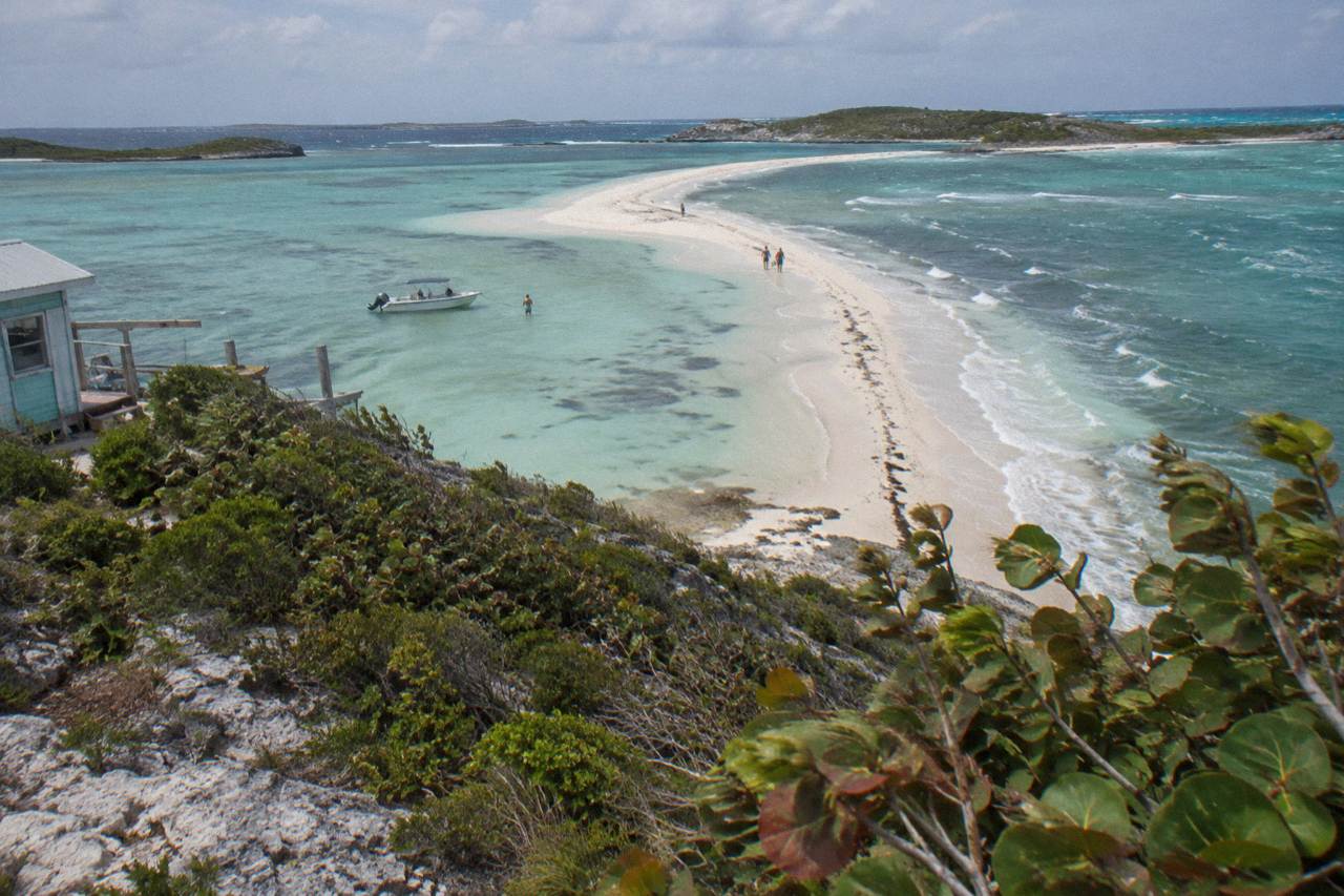 Turquoise shallow water around a small Exuma cay with a white sandbar