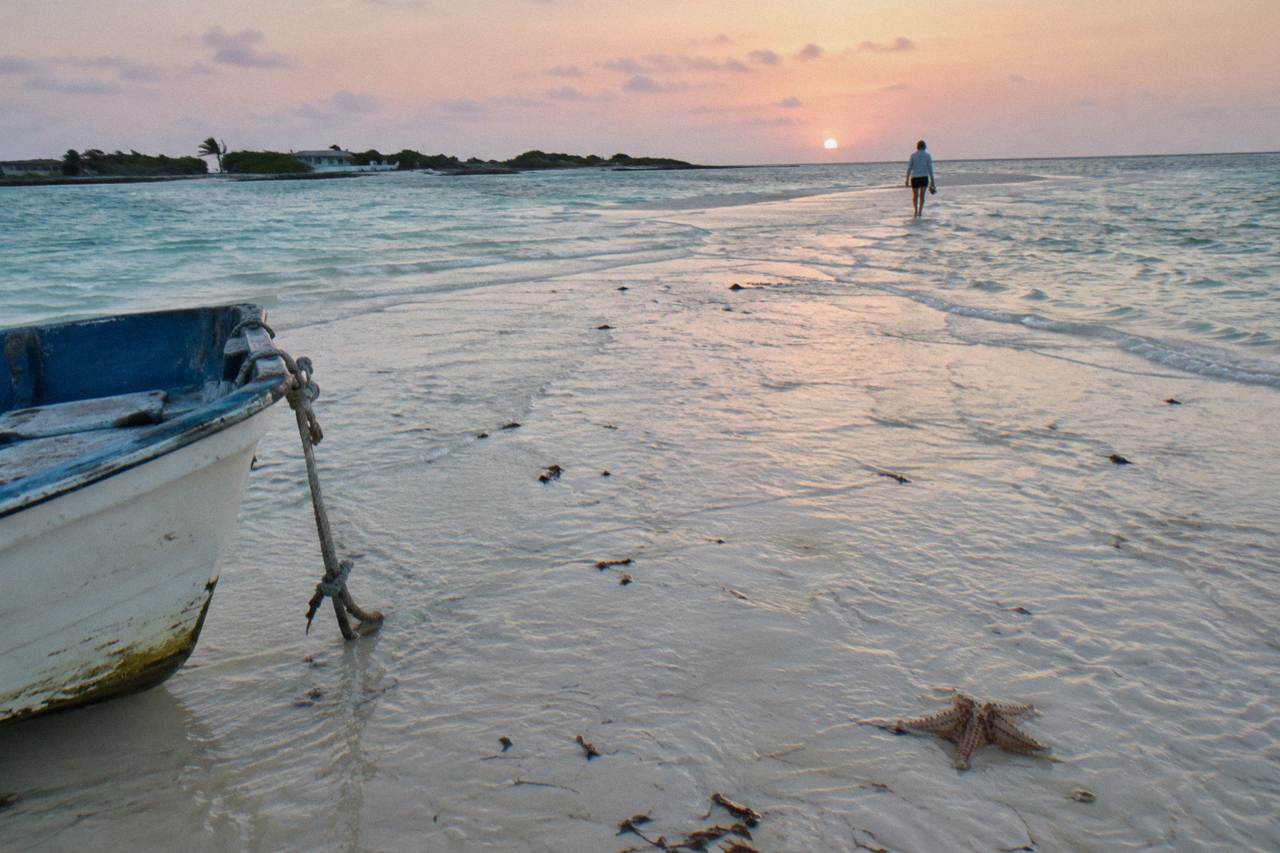 Turquoise shallow water along an empty Exuma sandbar under a clear sky