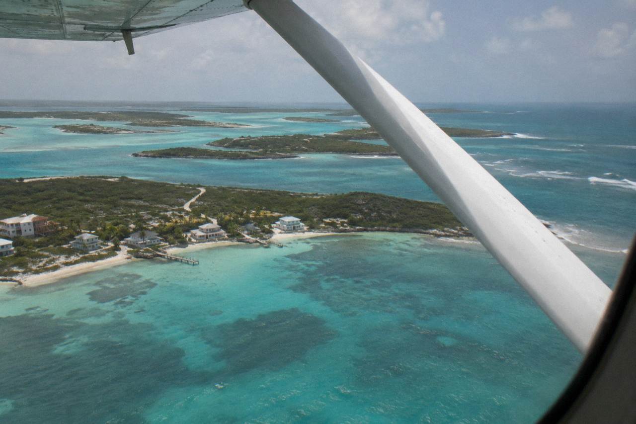 Turquoise shallow water around small Exuma cays seen from a light aircraft window