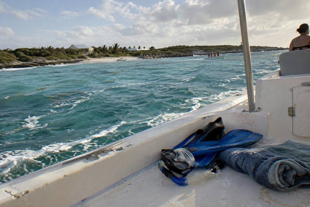 Snorkel gear and a towel laid out on a boat deck