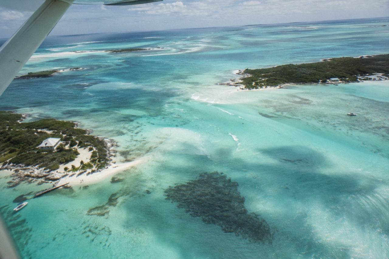 Turquoise shallow water and small cays seen from above in the Exumas