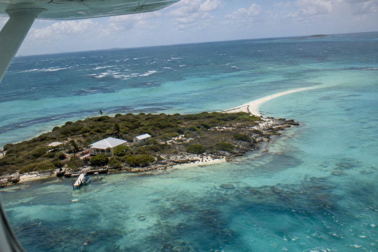 Turquoise shallow water around a small Exuma cay with a white sand spit