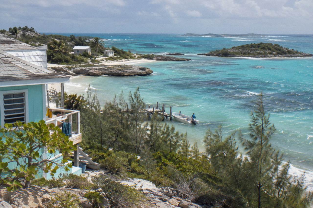 Turquoise shallow water and small cays along the Exuma coastline at midday